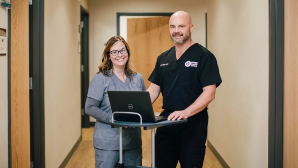 Dr. Eric Smith and nurse on laptop